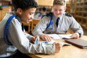 Boys in classroom learning with different techniques